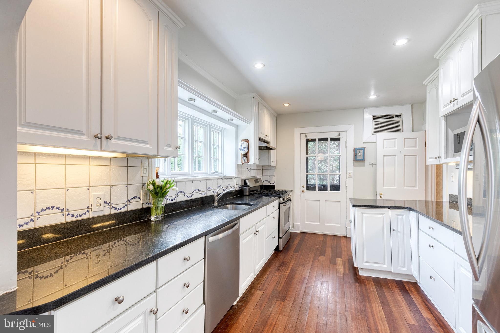 202 Taplow Road Baltimore, MD 21212 - Photo 14 of 56 a large kitchen with stainless steel appliances granite countertop a lot of counter space and wooden floor