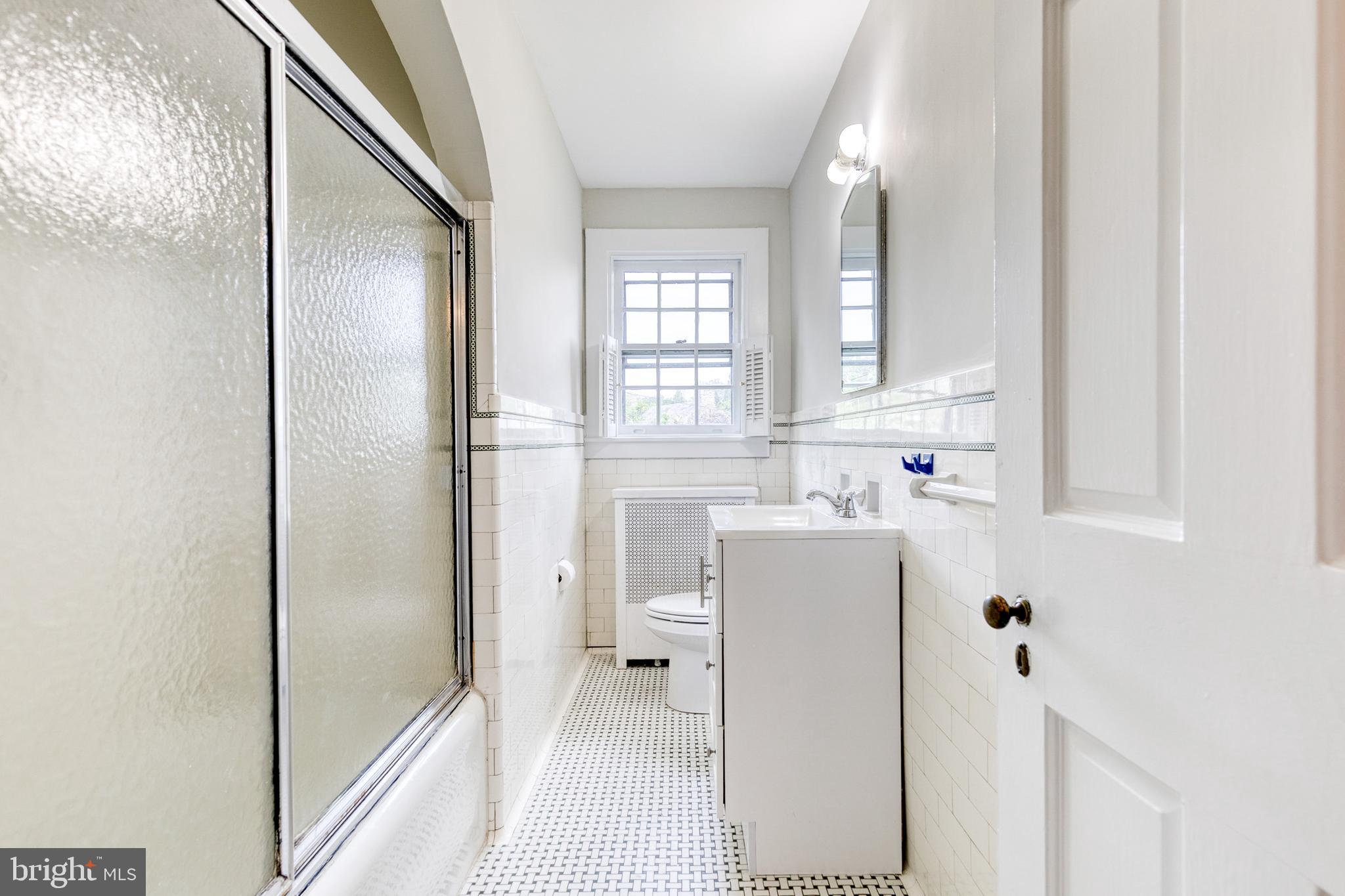 202 Taplow Road Baltimore, MD 21212 - Photo 37 of 56 a bathroom with a sink a toilet and shower