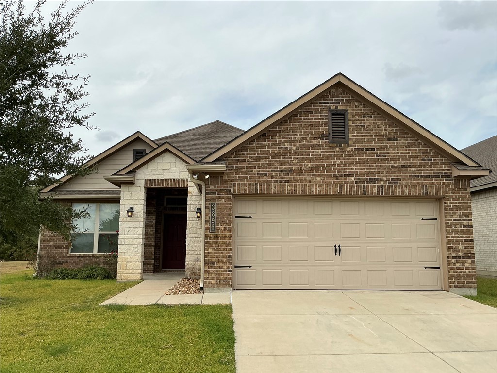 3896 Still Creek Loop College Station, TX 77845 - Photo 1 of 19 a front view of a house with a yard and garage