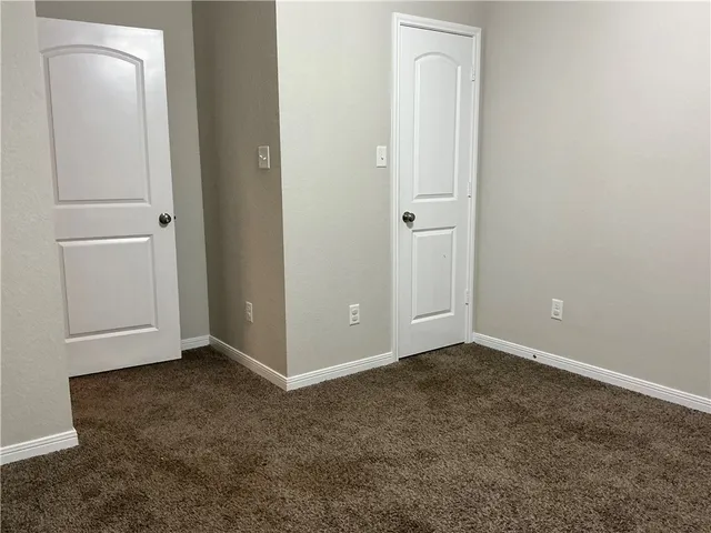 an empty room with closet area