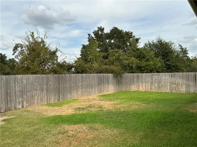 a swimming pool with trees in the background