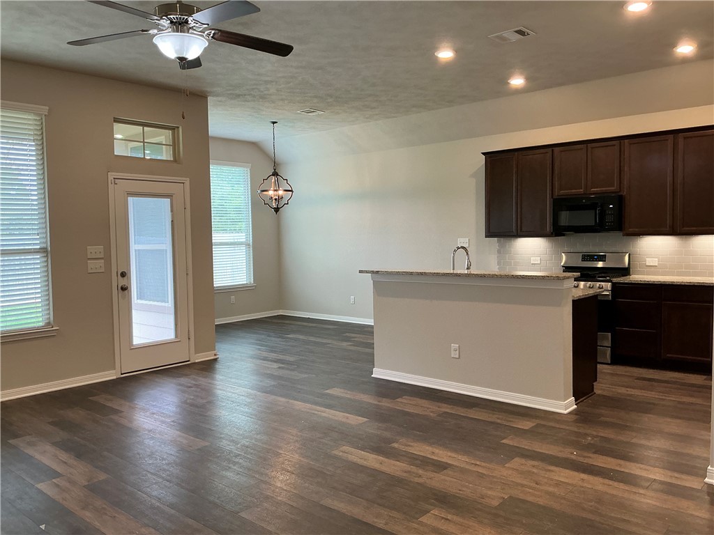 3896 Still Creek Loop College Station, TX 77845 - Photo 2 of 19 a kitchen with stainless steel appliances granite countertop a sink dishwasher a stove and a refrigerator