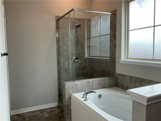 a bathroom with a bathtub and a shower