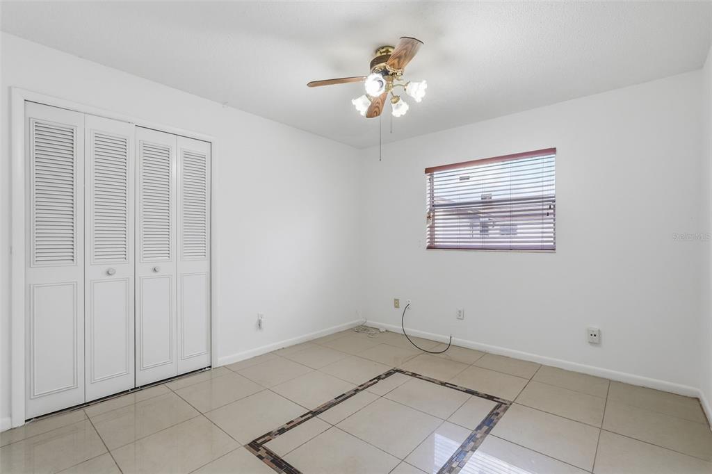 4848 Judy Ann Court Orlando, FL 32808 - Photo 23 of 39 a view of an empty room with a chandelier fan