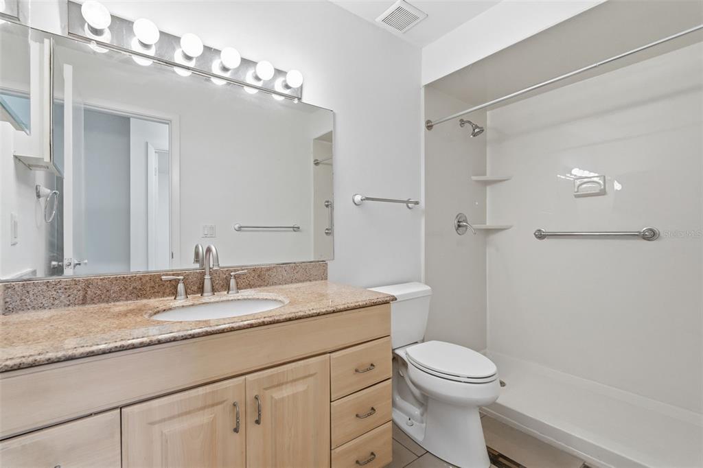 4848 Judy Ann Court Orlando, FL 32808 - Photo 25 of 39 a bathroom with a granite countertop sink a toilet and shower