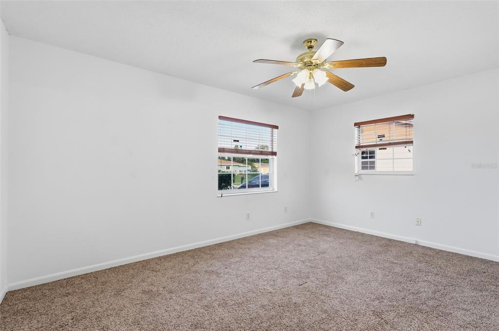 4848 Judy Ann Court Orlando, FL 32808 - Photo 26 of 39 an empty room with windows and fan