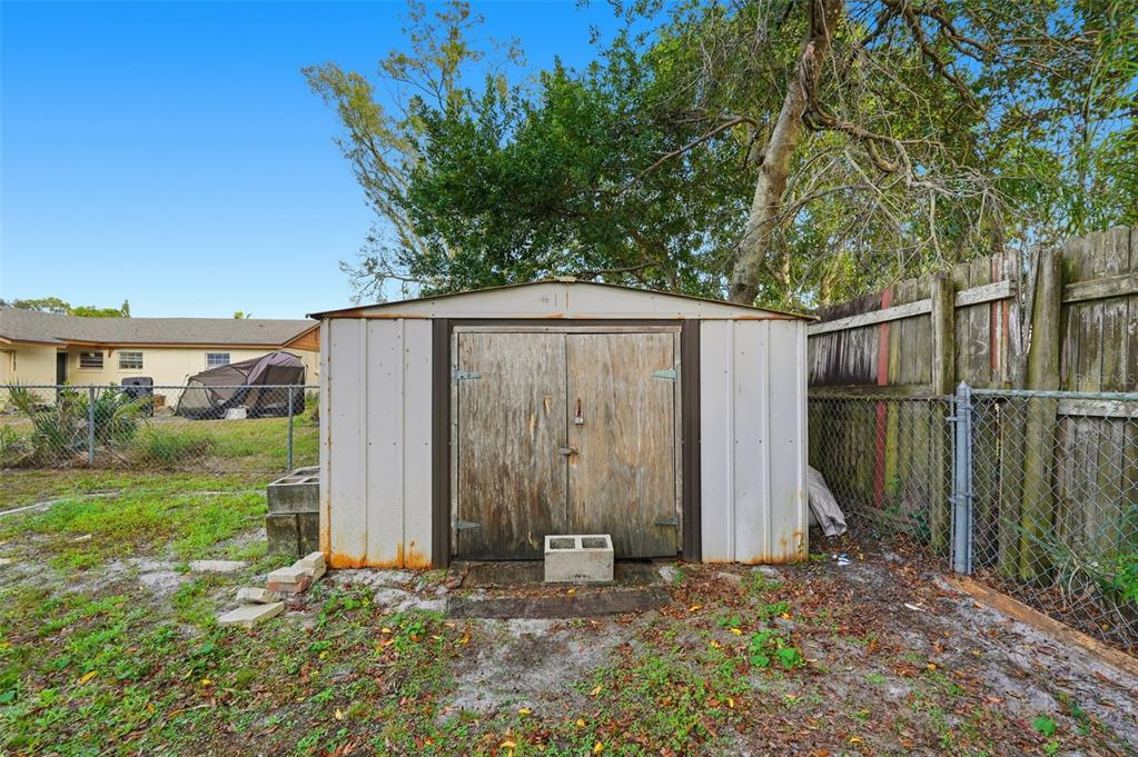 4848 Judy Ann Court Orlando, FL 32808 - Photo 31 of 39 a backyard of a house with plants and tree