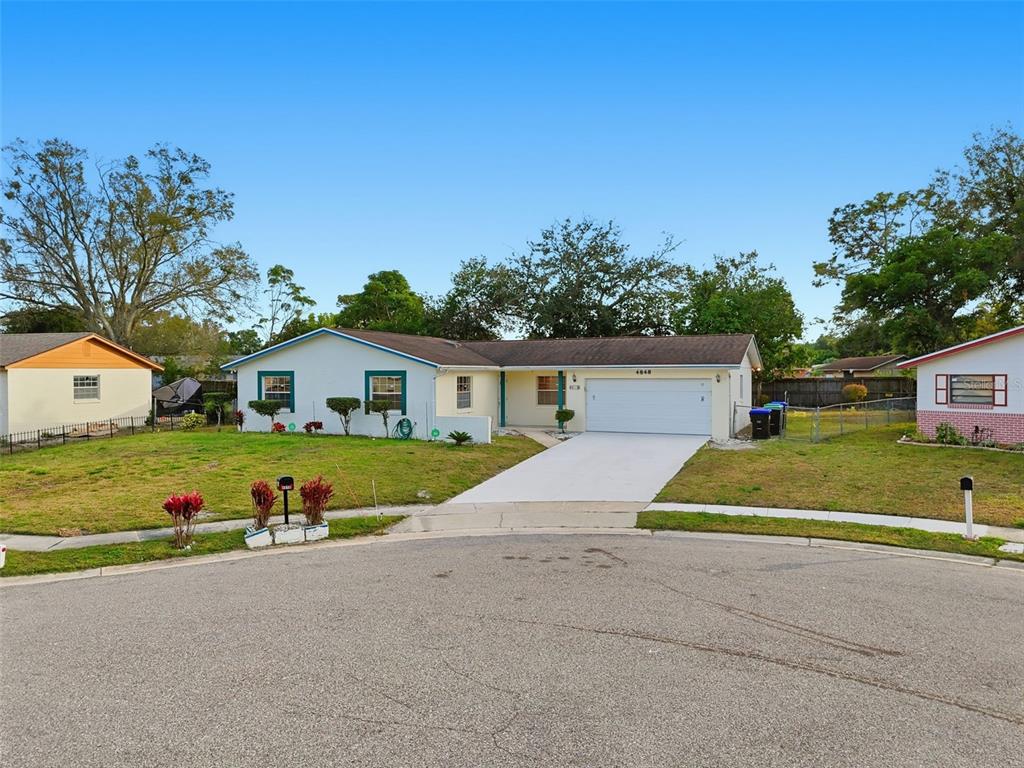 4848 Judy Ann Court Orlando, FL 32808 - Photo 4 of 39 a front view of a house with a yard and garage