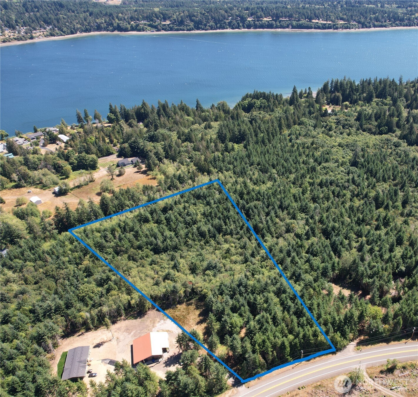 an aerial view of a house with a yard and lake view