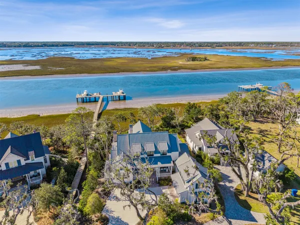 a living room with furniture large windows and a flat screen tv