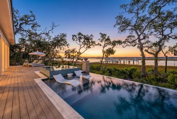a kitchen with stainless steel appliances granite countertop a sink a stove and a wooden floors