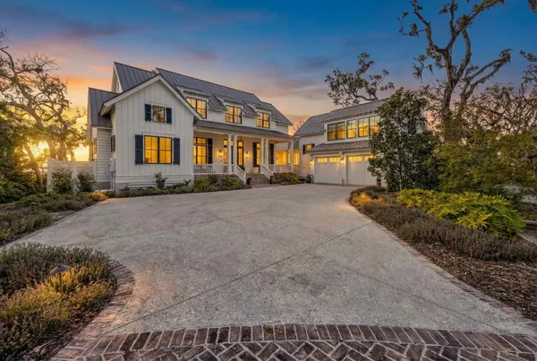 a view of a balcony with wooden floor and lake view
