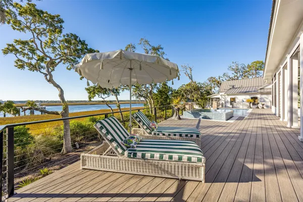 a view of a dining room with furniture a chandelier and wooden floor