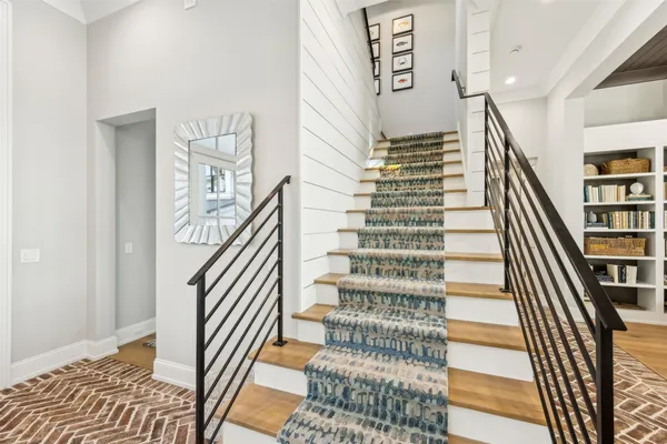 a living room with lots of furniture and chandelier