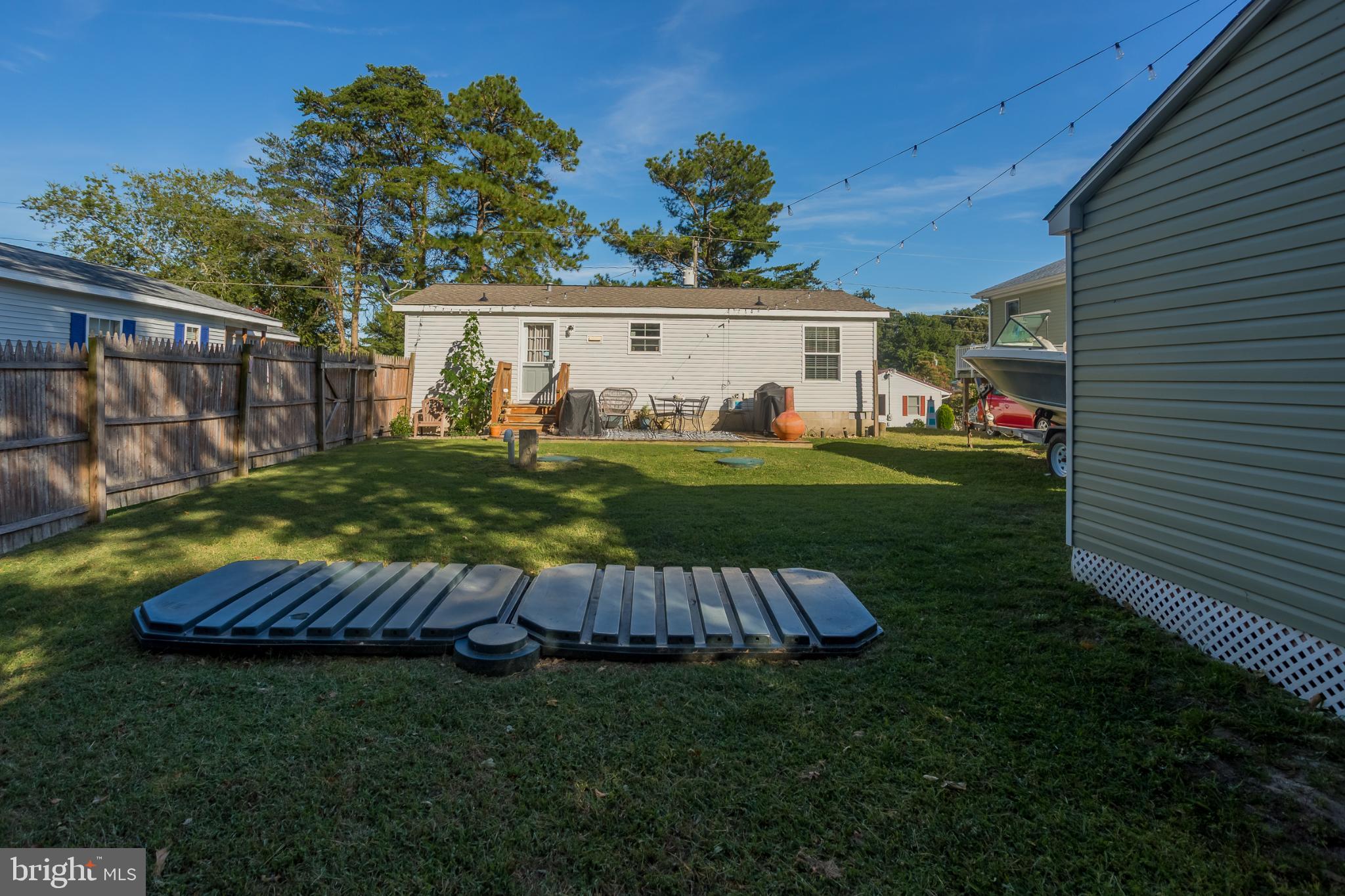30837 West Lagoon Road Dagsboro, DE 19939 - Photo 23 of 36 Spacious backyard with serene greenery.