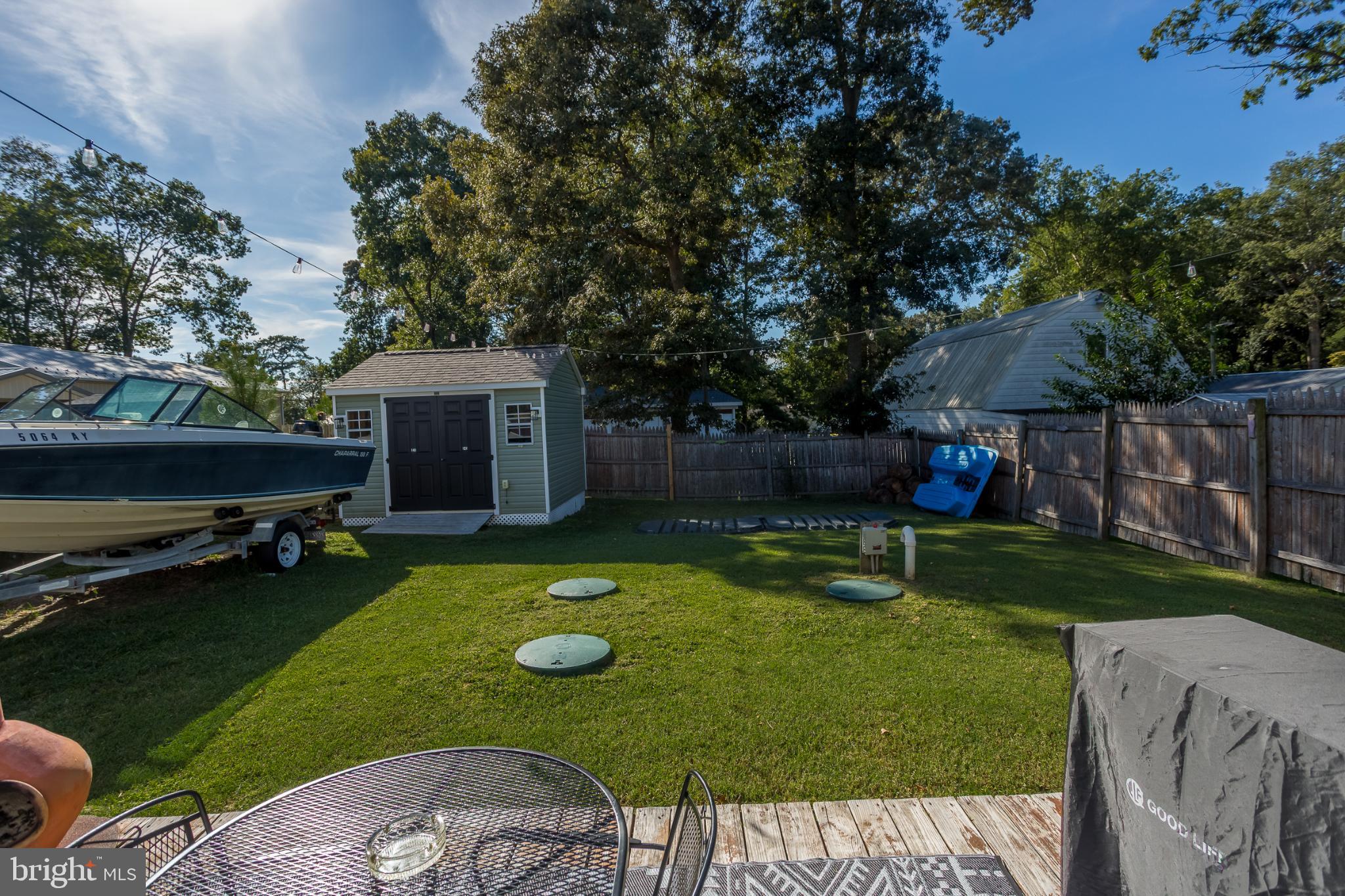 30837 West Lagoon Road Dagsboro, DE 19939 - Photo 25 of 36 Serene backyard with boat and shed.