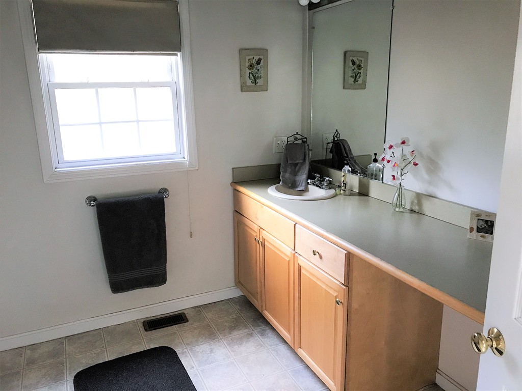 380 Richardson Road Dracut, MA 01826 - Photo 14 of 21 a bathroom with a sink and a mirror