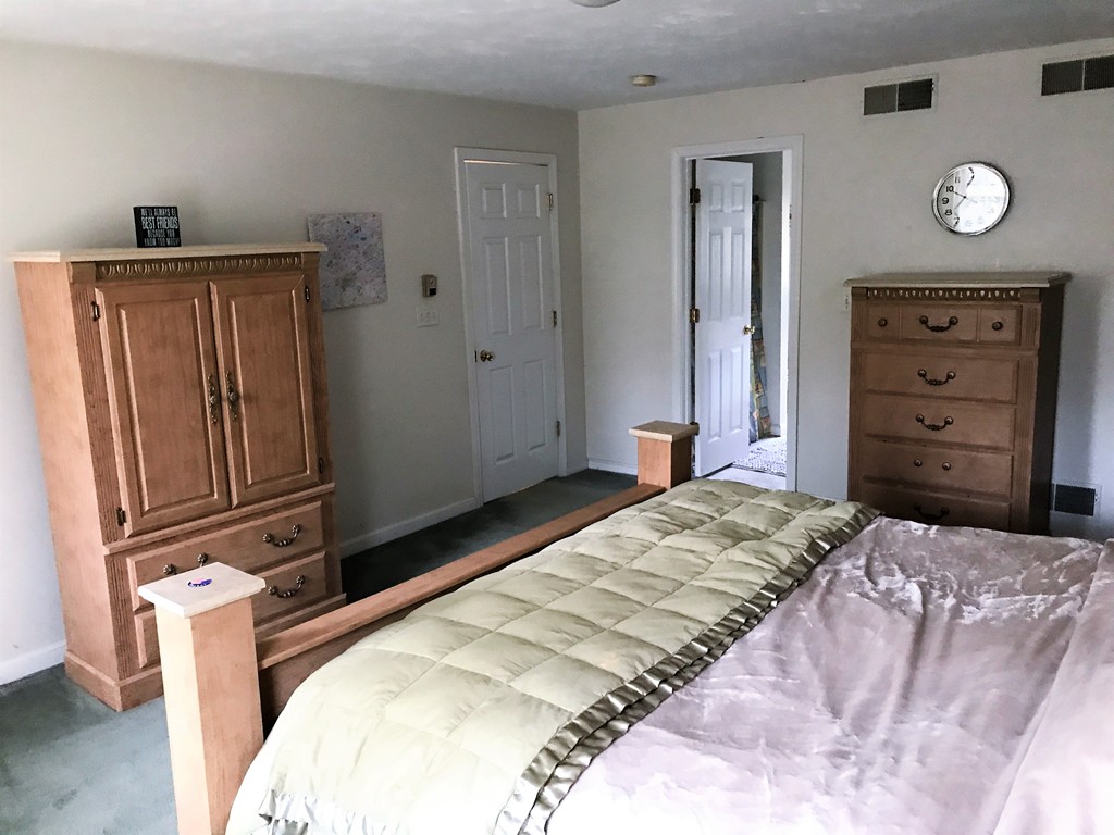 380 Richardson Road Dracut, MA 01826 - Photo 20 of 21 a bedroom with a bed and a dresser
