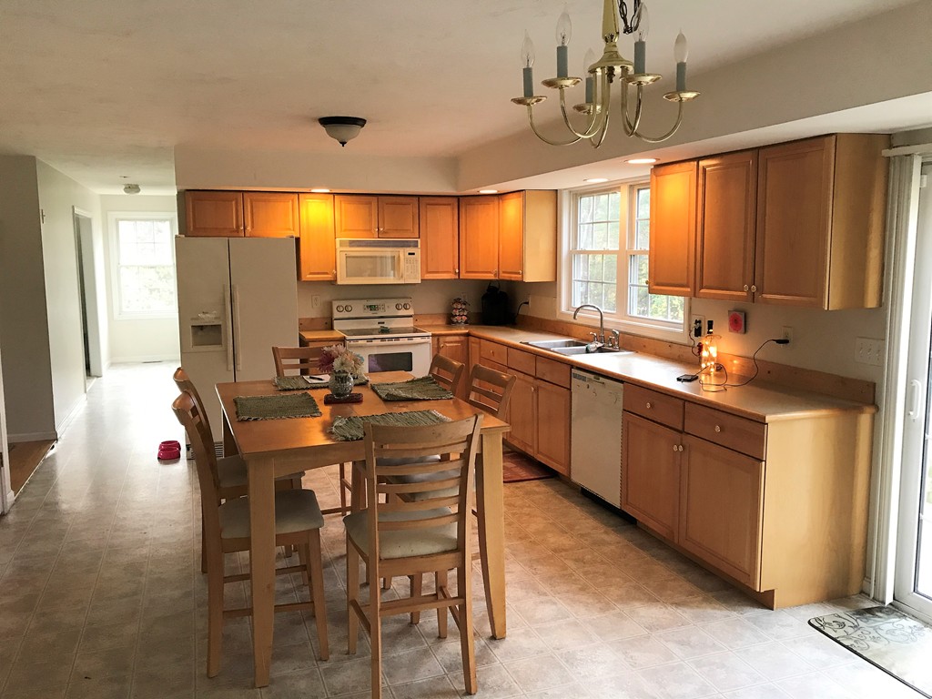 380 Richardson Road Dracut, MA 01826 - Photo 4 of 21 a large kitchen with a table and chairs
