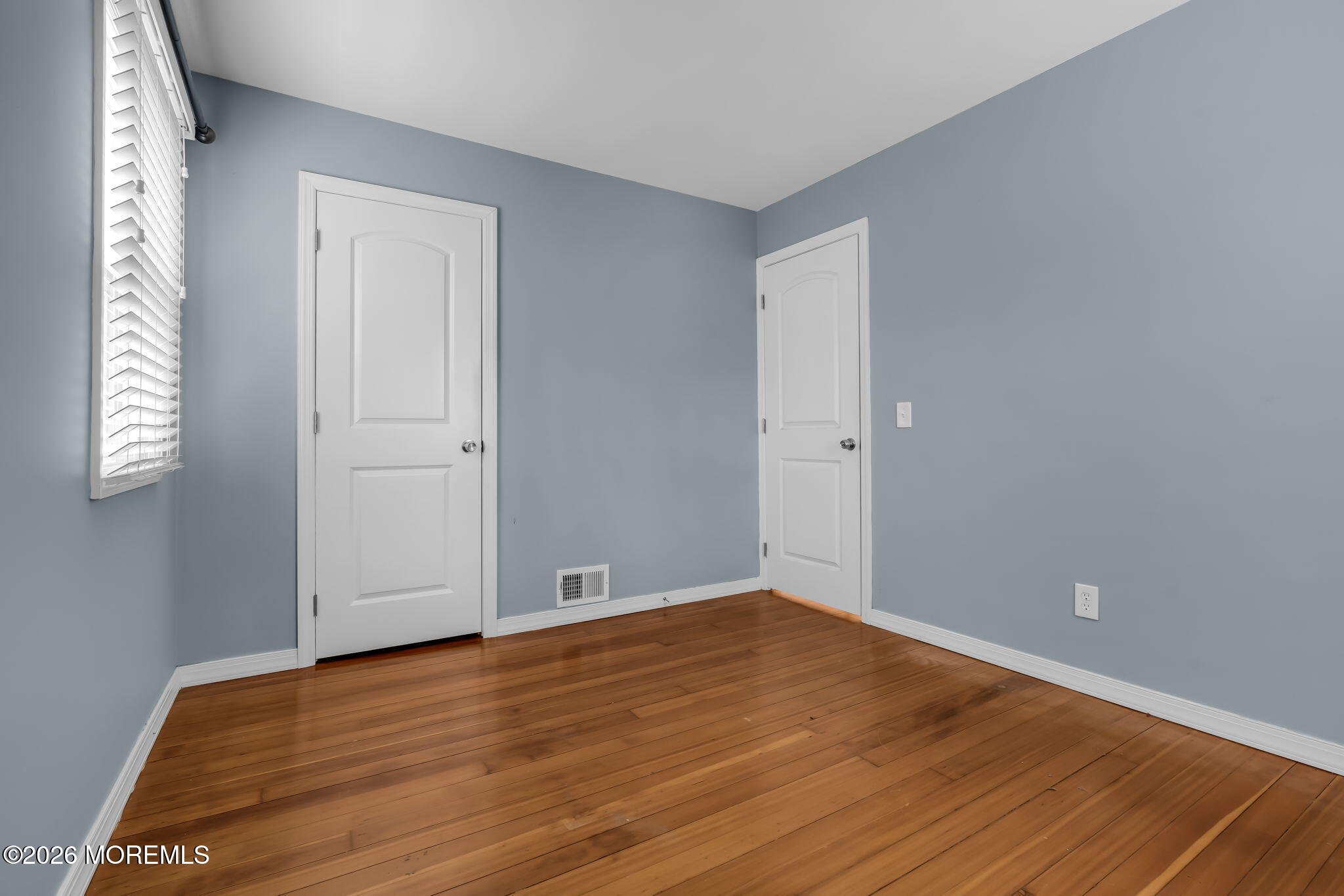 593 Beach Plum Road Brick, NJ 08723 - Photo 15 of 38 an empty room with wooden floor and windows