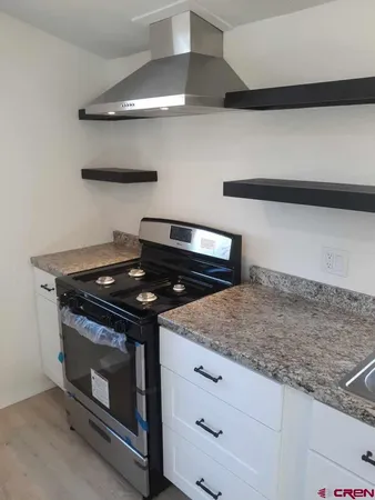 a stove top oven sitting inside of a kitchen