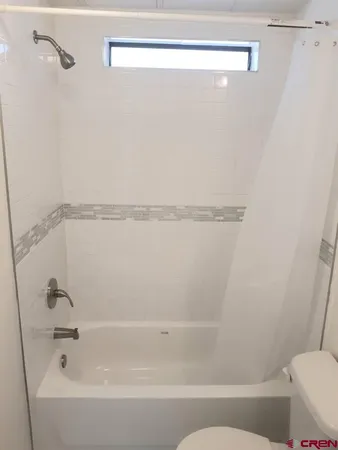 a bathroom with a shower and toilet