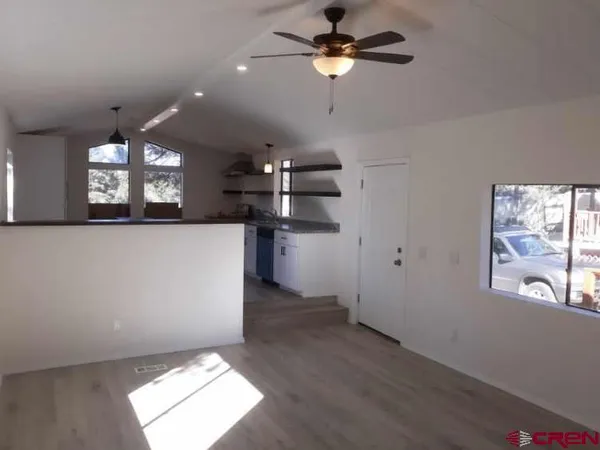 a view of a kitchen with a dishwasher cabinets and a large window