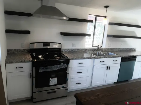 a kitchen with stainless steel appliances granite countertop a stove and a sink