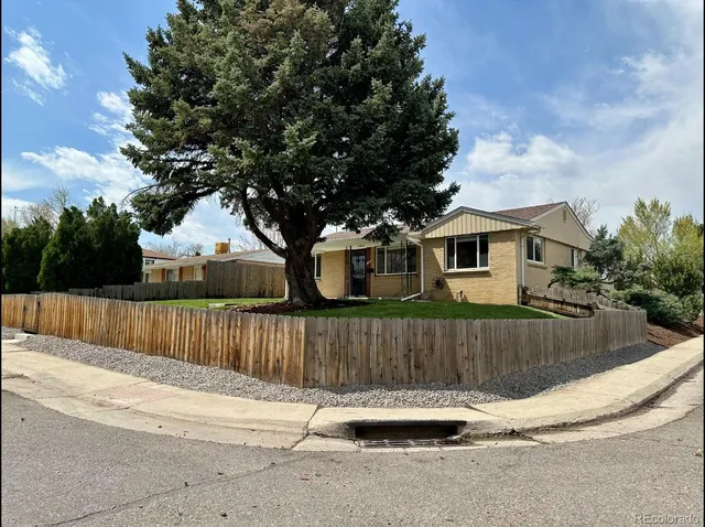 a view of a house with wooden fence