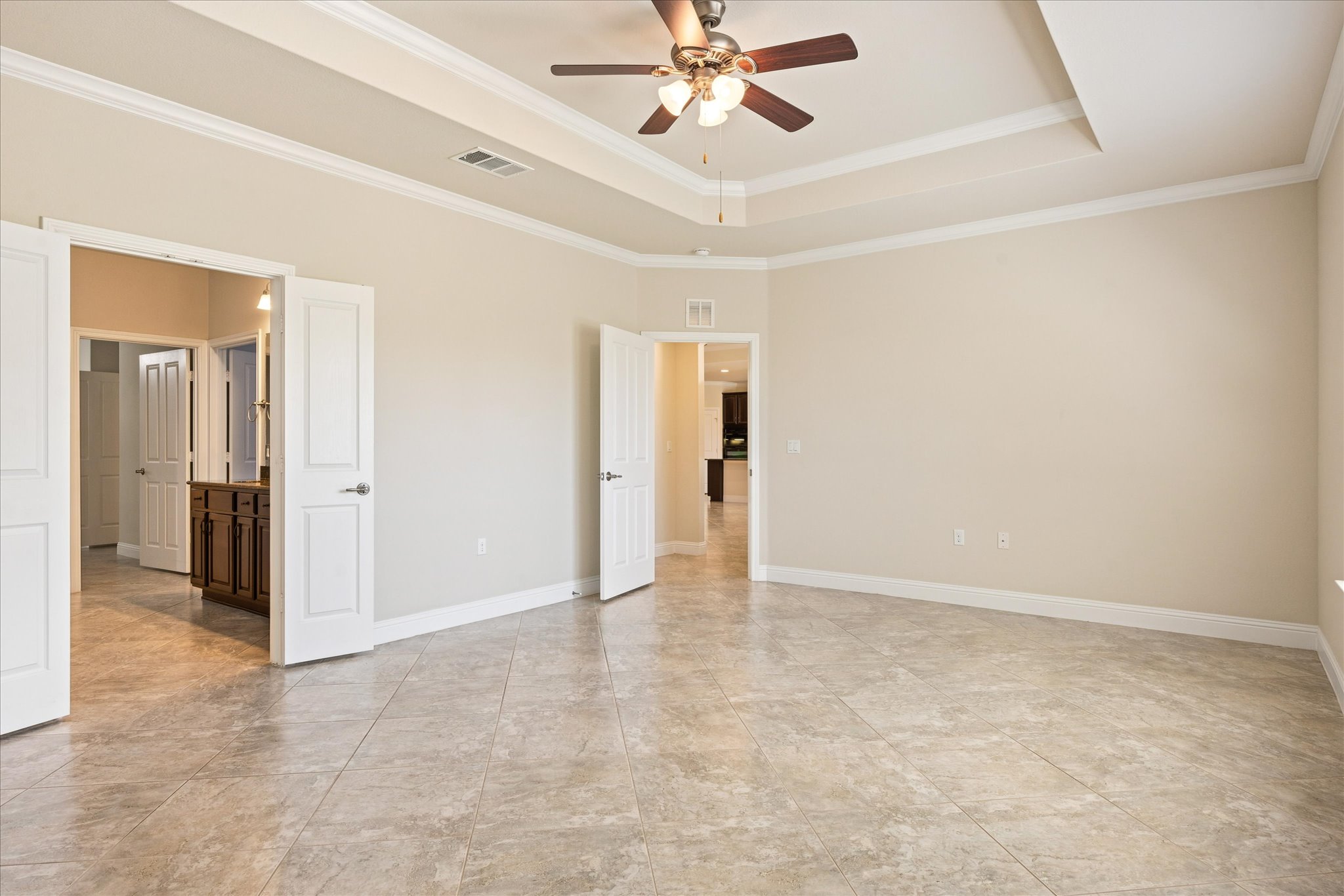 103 McKittrick Ridge Road Georgetown, TX 78633 - Photo 10 of 23 An elegant tray ceiling and durable tile flooring define this spacious main bedroom suite.