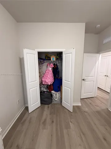 a view of a livingroom with wooden floor and closet