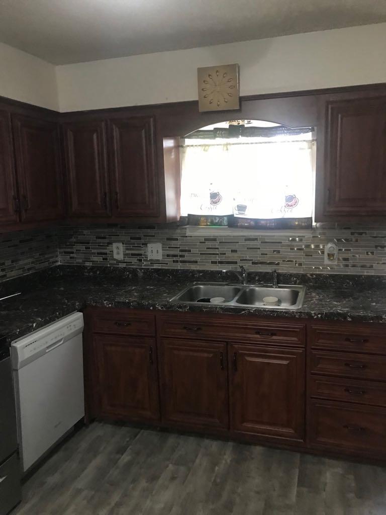 2907 Anderson Road Nashville, TN 37217 - Photo 12 of 12 a kitchen with stainless steel appliances granite countertop wooden cabinets a stove and a sink