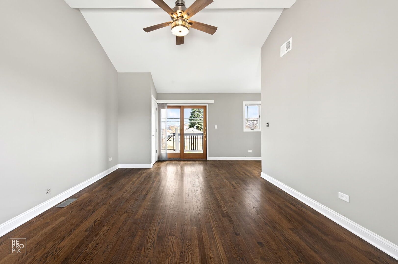 4680 West 83rd Street Chicago, IL 60652 - Photo 16 of 22 an empty room with wooden floor fan and windows
