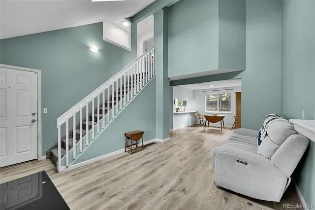 a living room with furniture and stairs