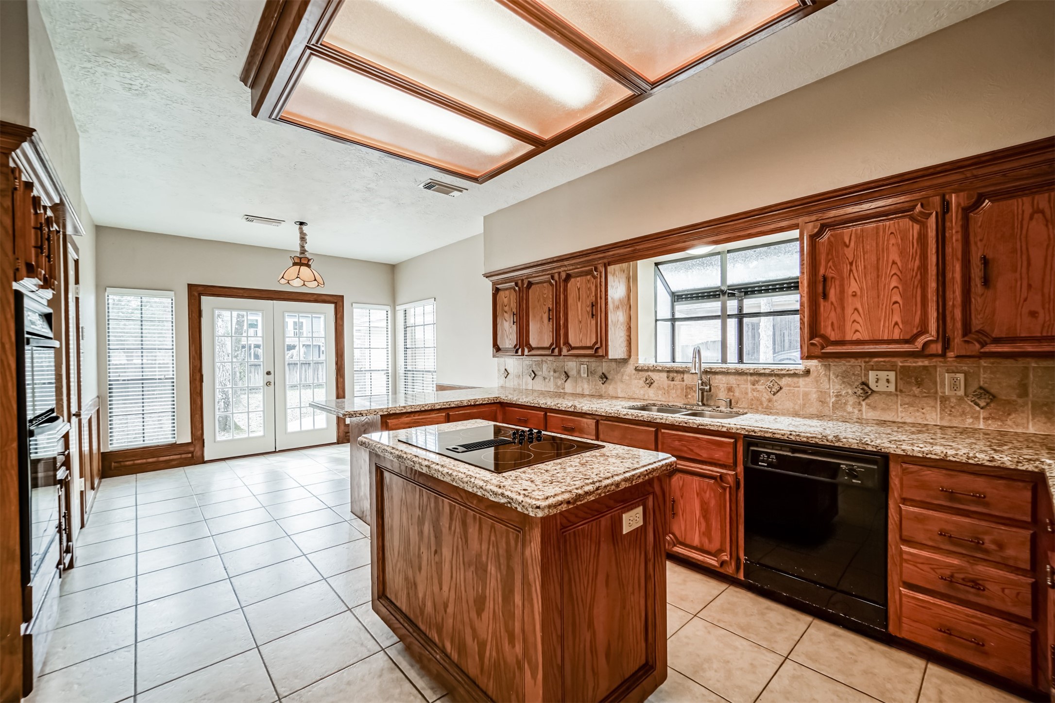 67 North Skyflower Court Spring, TX 77381 - Photo 11 of 45 a kitchen with stainless steel appliances granite countertop a stove a sink dishwasher and cabinets with wooden floor