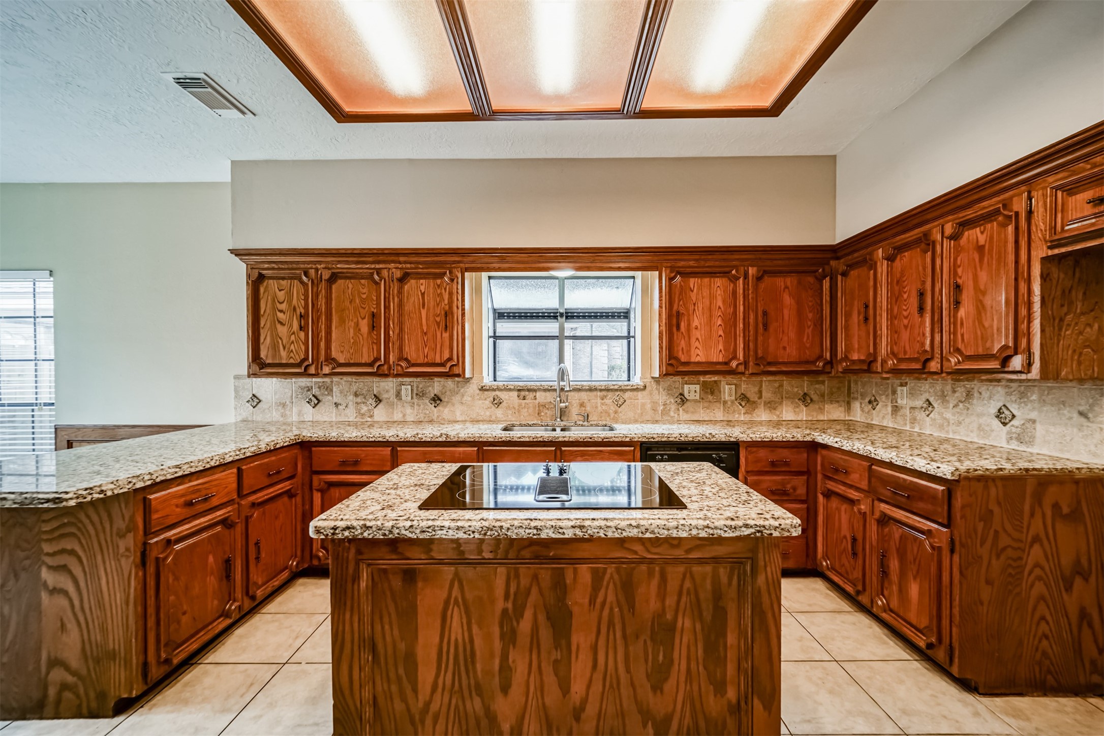 67 North Skyflower Court Spring, TX 77381 - Photo 12 of 45 a kitchen with stainless steel appliances granite countertop a stove a sink dishwasher and a microwave oven with cabinets
