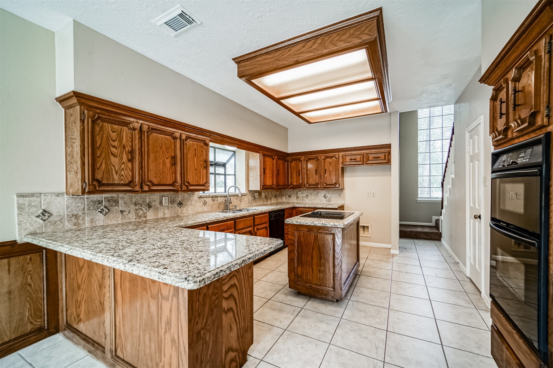 67 North Skyflower Court Spring, TX 77381 - Photo 14 of 45 a kitchen with a stove sink and cabinets