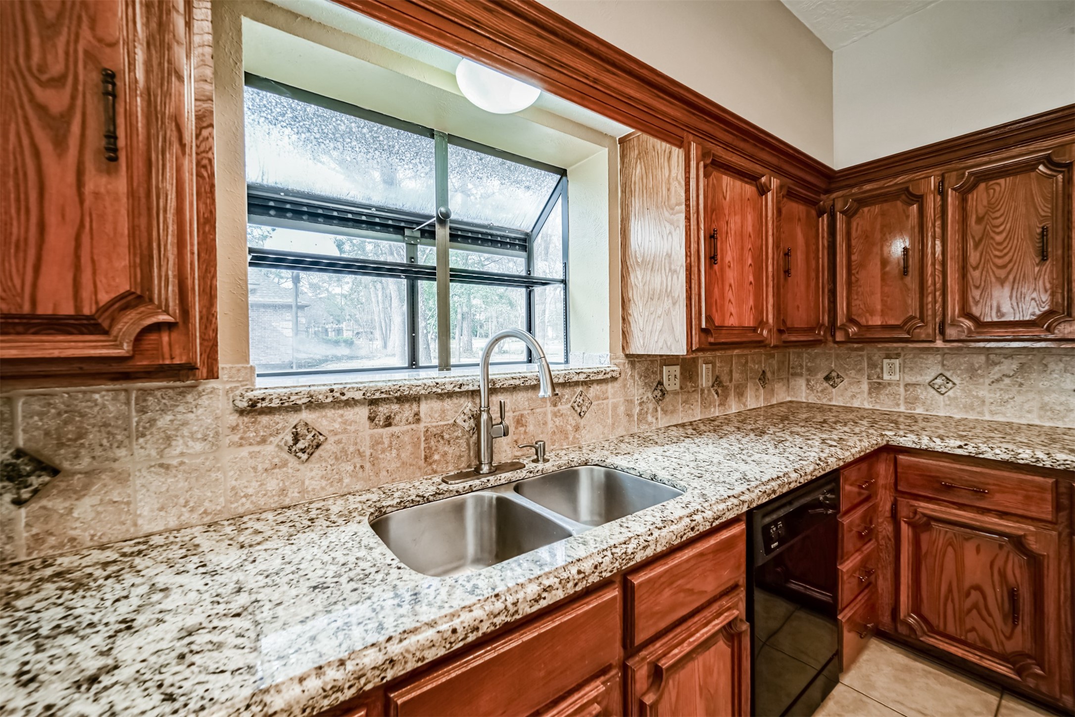 67 North Skyflower Court Spring, TX 77381 - Photo 16 of 45 a kitchen with stainless steel appliances granite countertop a sink a stove and cabinets