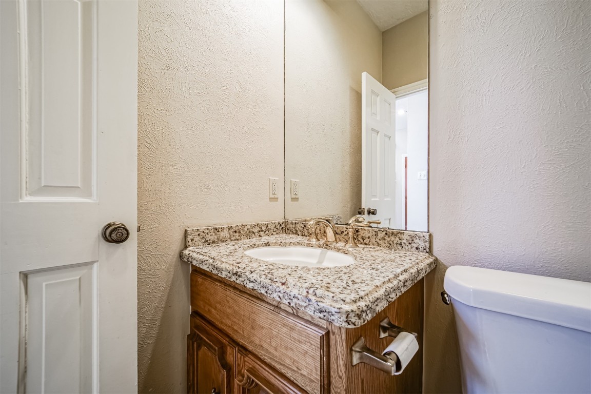 67 North Skyflower Court Spring, TX 77381 - Photo 19 of 45 a bathroom with a granite countertop sink and a mirror