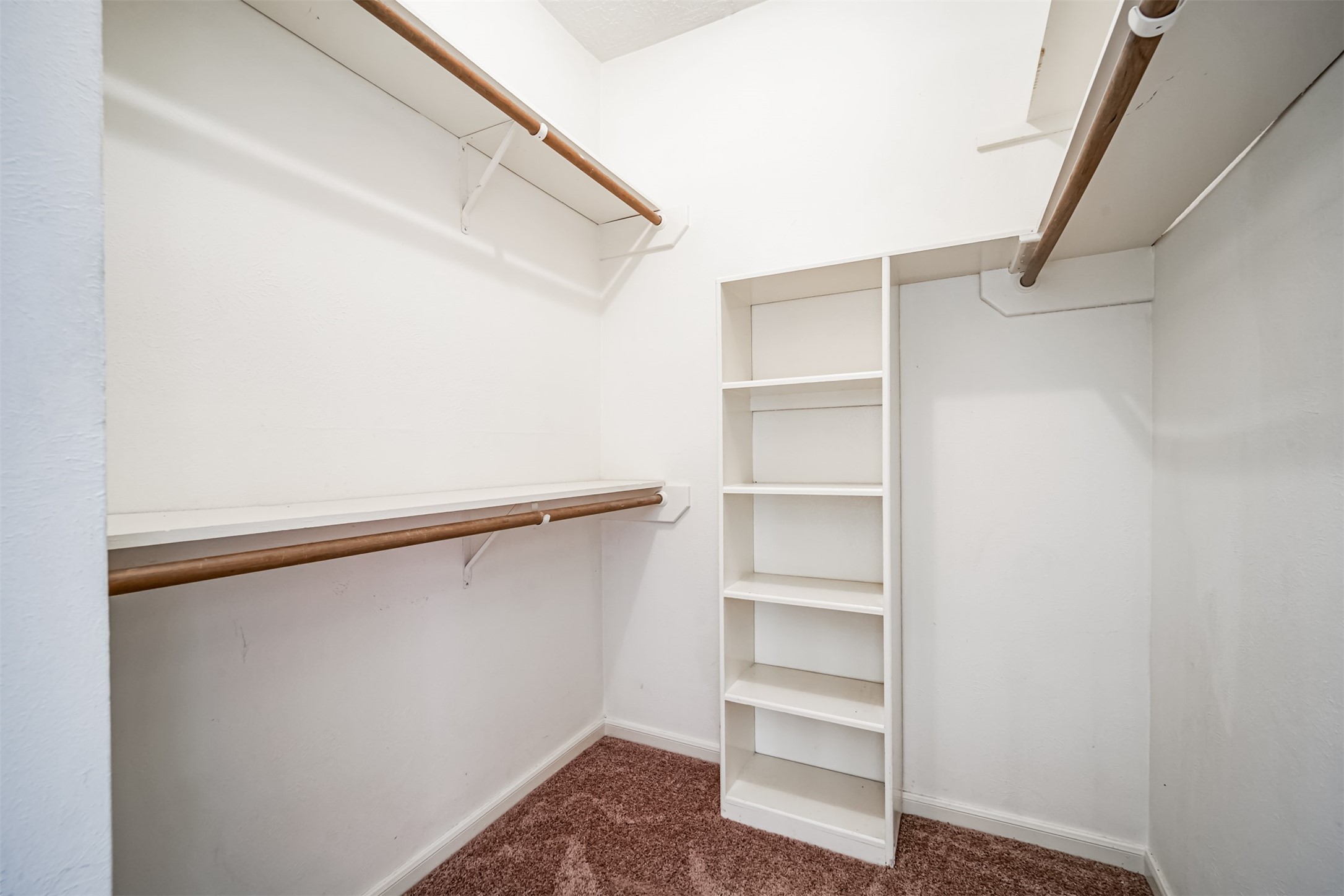 67 North Skyflower Court Spring, TX 77381 - Photo 26 of 45 a view of walk in closet with empty racks
