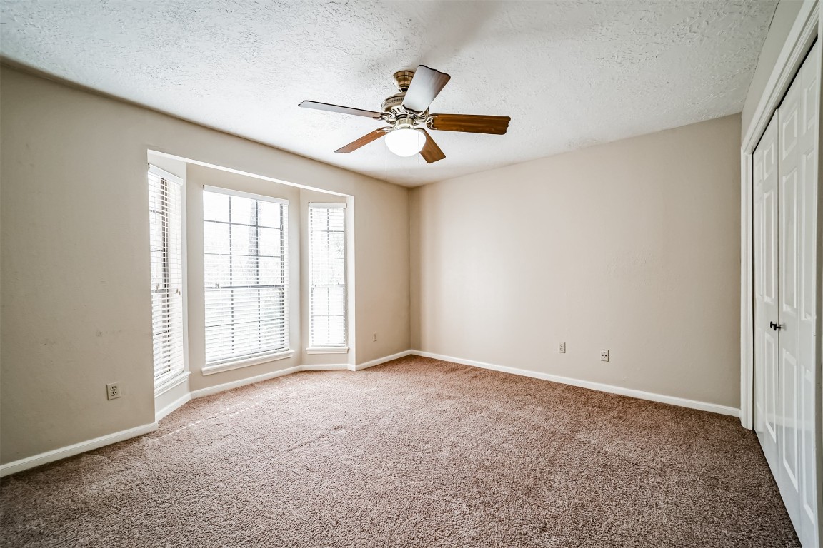 67 North Skyflower Court Spring, TX 77381 - Photo 32 of 45 an empty room with windows and fan