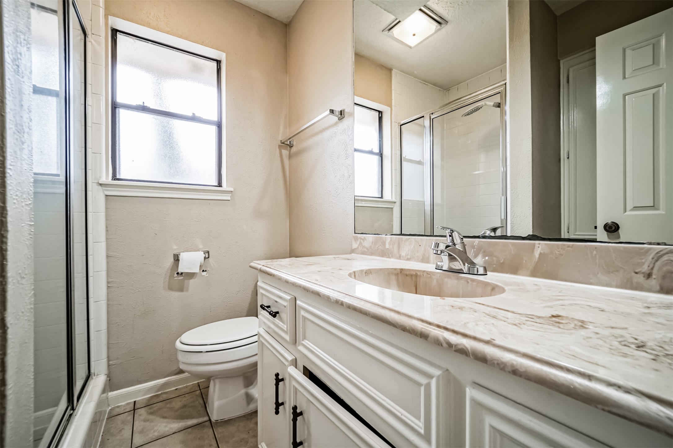 67 North Skyflower Court Spring, TX 77381 - Photo 39 of 45 a bathroom with a granite countertop sink a toilet and a mirror
