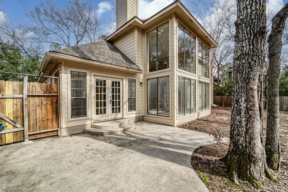 67 North Skyflower Court Spring, TX 77381 - Photo 43 of 45 a view of a house with a large windows and wooden fence