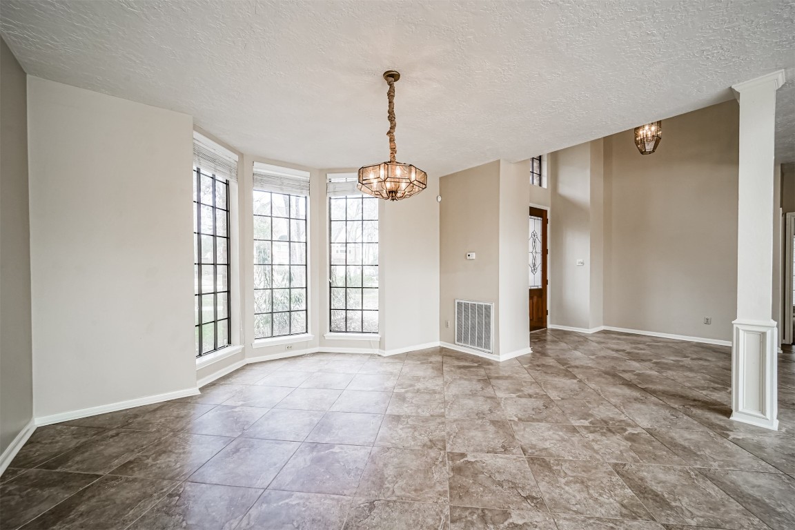 67 North Skyflower Court Spring, TX 77381 - Photo 8 of 45 a view of an empty room with window and chandelier fan
