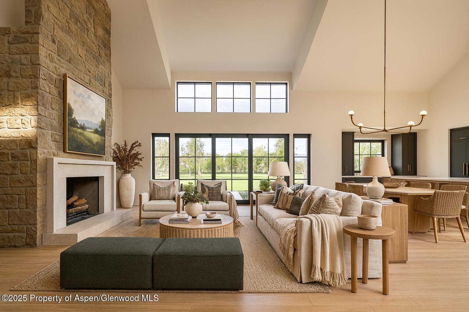 956 Bald Eagle Way Carbondale, CO 81623 - Photo 1 of 13 a living room with furniture a fireplace and a floor to ceiling window