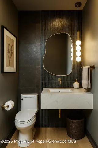 a bathroom with a toilet a sink and mirror