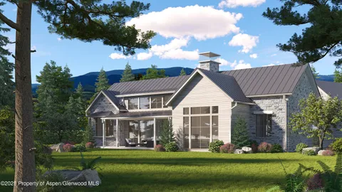 an aerial view of a house with a garden and lake view