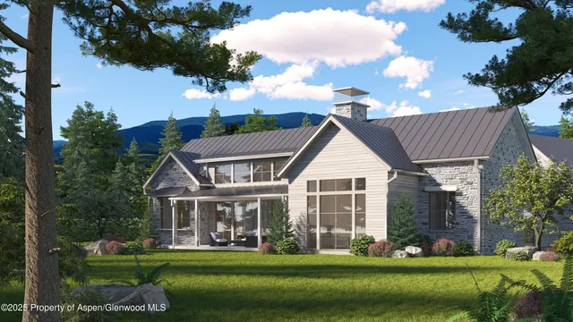 an aerial view of a house with a garden and lake view