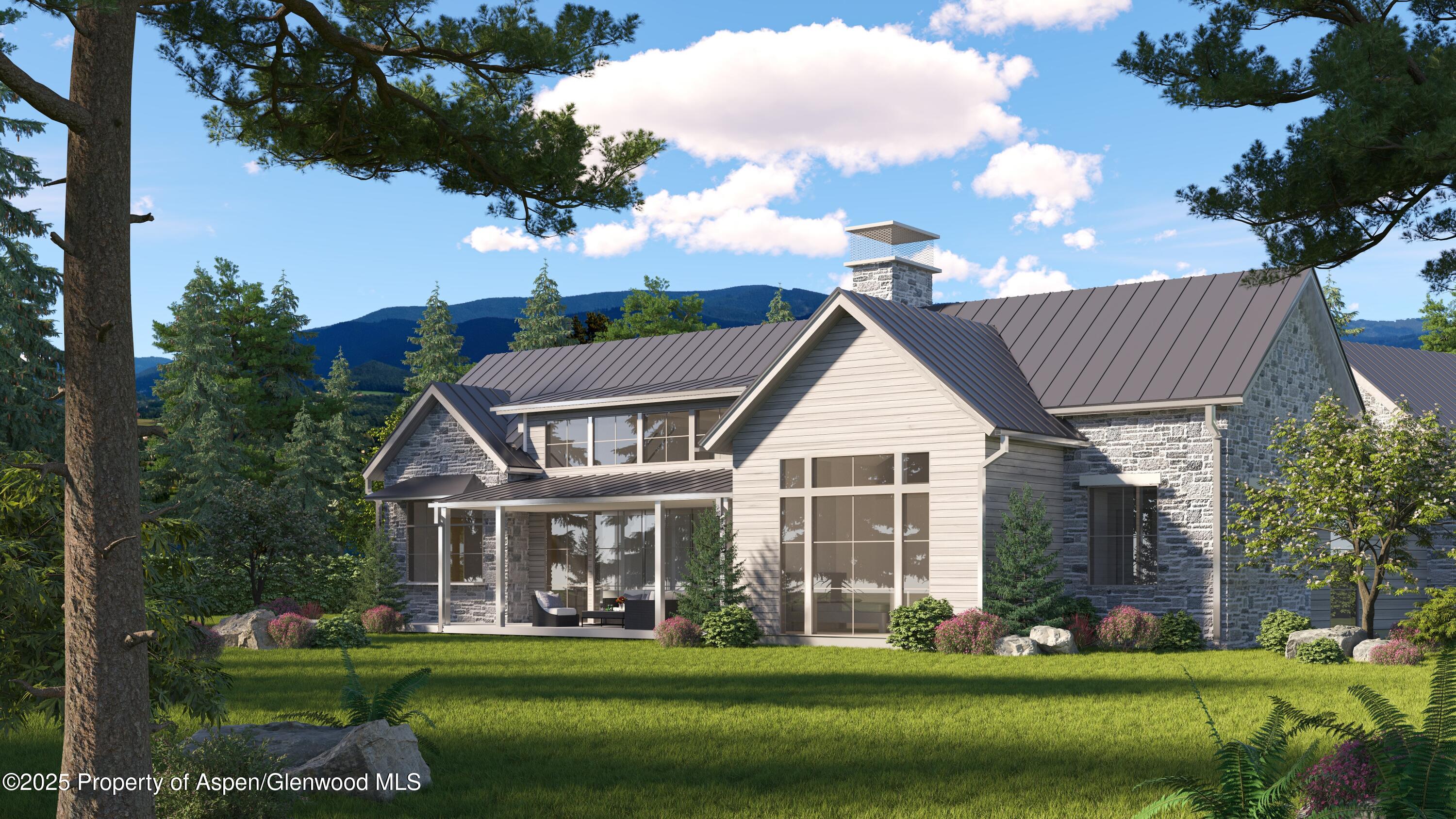 956 Bald Eagle Way Carbondale, CO 81623 - Photo 10 of 13 a front view of a house with a garden and trees