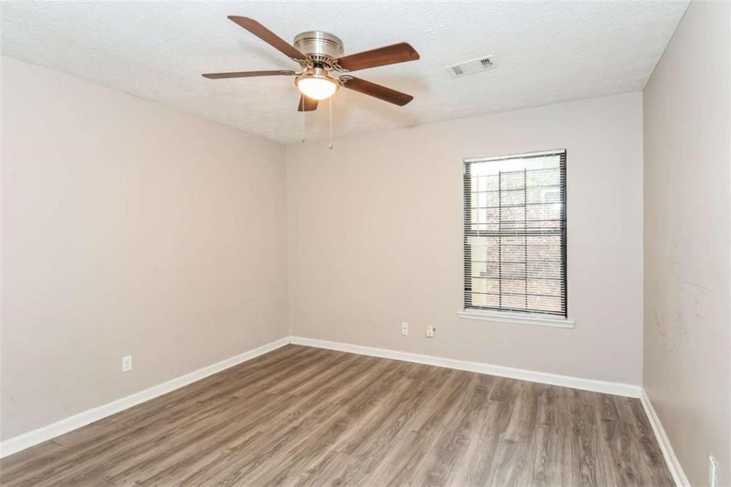 2356 Wingfoot Place Decatur, GA 30035 - Photo 13 of 20 an empty room with wooden floor fan and windows